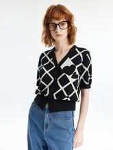 A lady wears a jacquard cardigan.